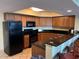 Modern kitchen with dark wood cabinets and granite countertops at 504 N Ocean Blvd. # 1003, Myrtle Beach, SC 29577