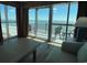 Bright living room with a view of the ocean and balcony access at 504 N Ocean Blvd. # 1003, Myrtle Beach, SC 29577