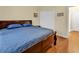 King-size bedroom with dark wood furniture, blue bedding, and double doors to closet at 541 Sand Ridge Rd., Conway, SC 29526