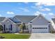 Charming single Gathering home featuring stone accents, a two-car garage, and manicured lawn at 541 Sand Ridge Rd., Conway, SC 29526