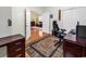 Home office with wood desk, chair, and view into living room at 541 Sand Ridge Rd., Conway, SC 29526