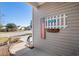 Side yard view with walkway and American flag decor at 5522 Elba Way # 5522, Myrtle Beach, SC 29579