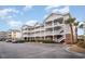 Exterior view of a multi-unit building with parking and landscaping at 5751 Oyster Catcher Dr. # 931, North Myrtle Beach, SC 29582