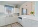 White kitchen with appliances, ample counter space, and striped wallpaper at 5751 Oyster Catcher Dr. # 931, North Myrtle Beach, SC 29582