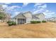 A screened porch and manicured shrubs enhance the backyard of this lovely home with a view to the pond at 6244 Catalina Dr. # 1411, North Myrtle Beach, SC 29582