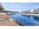 Snow-covered landscape with a tranquil pond, reflecting houses in the background at 6244 Catalina Dr. # 1411, North Myrtle Beach, SC 29582