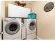 Dedicated laundry room features front-loading washer and dryer, white cabinets, and modern appliances at 6244 Catalina Dr. # 1411, North Myrtle Beach, SC 29582