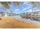 Scenic view of a pond reflecting surrounding homes and blue skies, creating a tranquil community atmosphere at 6244 Catalina Dr. # 1411, North Myrtle Beach, SC 29582