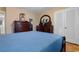 Bedroom with dark wood dresser and blue bedding at 676 Pelican Ave. # 676, Myrtle Beach, SC 29577