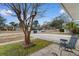 Inviting front yard view with mature trees and a sitting area at 676 Pelican Ave. # 676, Myrtle Beach, SC 29577