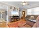 Living room with fireplace, large TV, and view into kitchen at 676 Pelican Ave. # 676, Myrtle Beach, SC 29577