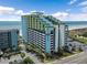 Aerial view of beachfront building with parking at 6804 N Ocean Blvd. # 1117, Myrtle Beach, SC 29572