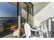 Balcony with chairs and sliding doors leading to the living area at 6804 N Ocean Blvd. # 1117, Myrtle Beach, SC 29572