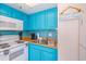 Fully equipped kitchen with teal cabinets and appliances at 6804 N Ocean Blvd. # 1637, Myrtle Beach, SC 29572