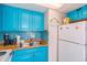 Clean and bright kitchen with teal cabinets and stainless steel appliances at 6804 N Ocean Blvd. # 1637, Myrtle Beach, SC 29572