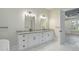 Double vanity bathroom with white cabinets, granite countertops, and marble flooring at 7053 Byrnes Ln., Myrtle Beach, SC 29588