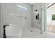 Elegant bathroom featuring soaking tub, tile walls, glass shower, and modern black fixtures at 7053 Byrnes Ln., Myrtle Beach, SC 29588