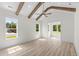 Bright bedroom features vaulted ceiling with exposed beams and large windows, creating an airy space at 7053 Byrnes Ln., Myrtle Beach, SC 29588