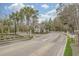 Gated community entrance featuring lush landscaping, palm trees, and controlled access for residents' peace of mind at 7053 Byrnes Ln., Myrtle Beach, SC 29588