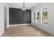 Bright dining room with paneled accent wall, wood flooring, and natural light creates an elegant ambiance at 7053 Byrnes Ln., Myrtle Beach, SC 29588