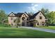 Stunning two-story brick home with manicured lawn, palm trees, and driveway provides curb appeal and a welcoming entrance at 7053 Byrnes Ln., Myrtle Beach, SC 29588