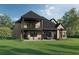 Spacious backyard with covered porch, balcony, and lush green lawn is great for outdoor entertaining and relaxation at 7053 Byrnes Ln., Myrtle Beach, SC 29588