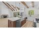 Open concept kitchen boasts an island, marble countertops, stainless steel appliances, and vaulted ceilings at 7053 Byrnes Ln., Myrtle Beach, SC 29588