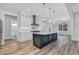 Bright kitchen featuring stainless steel appliances, central island, stylish lighting, and ample cabinet space at 7053 Byrnes Ln., Myrtle Beach, SC 29588