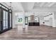 Open-concept living space with hardwood floors, modern black windows, and a view into the kitchen at 7053 Byrnes Ln., Myrtle Beach, SC 29588