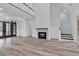 Elegant living room featuring high ceilings, modern fireplace, hardwood floors, and natural light, for luxurious comfort at 7053 Byrnes Ln., Myrtle Beach, SC 29588