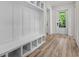 Inviting mudroom featuring built-in bench with storage and wood-look flooring for organized entry at 7053 Byrnes Ln., Myrtle Beach, SC 29588