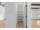 Bright pantry featuring white shelving and a wood-look floor for organized storage and easy access at 7053 Byrnes Ln., Myrtle Beach, SC 29588