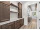 Butler pantry with built in cabinets, open shelving, and marble countertops at 7053 Byrnes Ln., Myrtle Beach, SC 29588