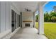 Covered outdoor patio with brick fireplace and exterior access via sliding glass doors at 7053 Byrnes Ln., Myrtle Beach, SC 29588