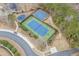 Aerial view of community recreation area with a playground, tennis court, and basketball court surrounded by landscaping at 7053 Byrnes Ln., Myrtle Beach, SC 29588