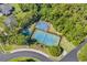 Aerial view of tennis and basketball courts surrounded by trees, offering recreational activities at 7053 Byrnes Ln., Myrtle Beach, SC 29588