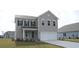 Two-story house with gray siding, a two-car garage, and landscaping at 7073 Shooting Star Way, Myrtle Beach, SC 29579