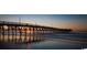 Sunrise over the ocean with pier in foreground at 719 Isle Verde Dr, Myrtle Beach, SC 29579