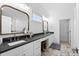 Double vanity bathroom with dark countertops and marble floors at 744 Crystal Water Way, Myrtle Beach, SC 29579