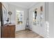 Light-filled entryway with white door and wood flooring at 744 Crystal Water Way, Myrtle Beach, SC 29579