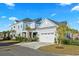 Two-story home with attached garage and manicured lawn at 744 Crystal Water Way, Myrtle Beach, SC 29579