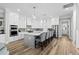 Modern kitchen with white cabinets, large island, and stainless steel appliances at 744 Crystal Water Way, Myrtle Beach, SC 29579