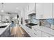 Modern kitchen with white cabinets, stainless steel appliances and a gas cooktop at 744 Crystal Water Way, Myrtle Beach, SC 29579