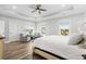 Bright and airy main bedroom with seating area and ceiling fan at 744 Crystal Water Way, Myrtle Beach, SC 29579