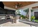 Outdoor kitchen with brick grill, granite countertop, and seating area at 744 Crystal Water Way, Myrtle Beach, SC 29579