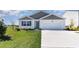 Newly built home with gray siding, white trim, and a two-car garage at 809 Green Garden Way, Myrtle Beach, SC 29579