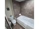 Bathroom with toilet, bathtub, and tiled floor at 8560 Queensway Blvd. # 304, Myrtle Beach, SC 29572