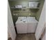 Laundry closet with washer and dryer, shelving above at 8560 Queensway Blvd. # 304, Myrtle Beach, SC 29572