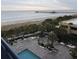 Aerial view of oceanfront pool and grounds with palm trees at 8560 Queensway Blvd. # 304, Myrtle Beach, SC 29572