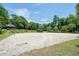 Sand volleyball court with net and surrounding trees at 8560 Queensway Blvd. # 304, Myrtle Beach, SC 29572